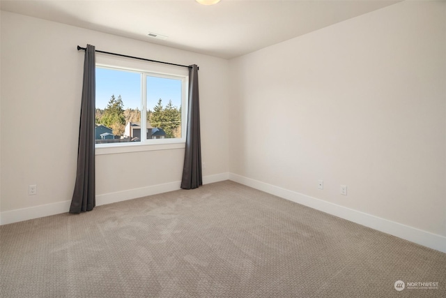 unfurnished room with light colored carpet