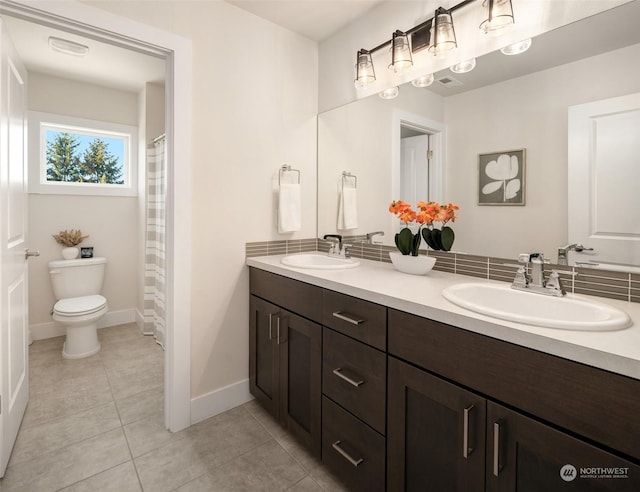 bathroom featuring vanity, tile patterned floors, and toilet