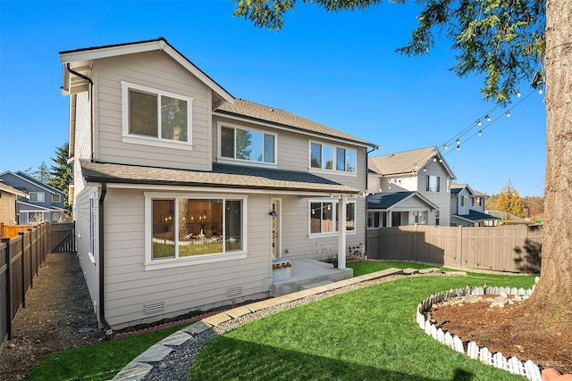 rear view of house featuring a patio area and a lawn