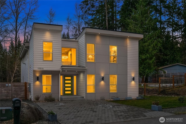 contemporary home with fence