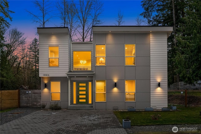 modern home with crawl space, a gate, fence, and a yard