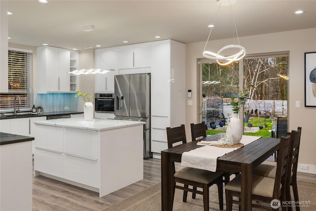 kitchen with open shelves, stainless steel appliances, white cabinets, a sink, and modern cabinets