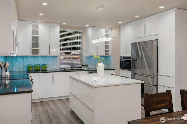 kitchen with open shelves, appliances with stainless steel finishes, white cabinets, a sink, and modern cabinets