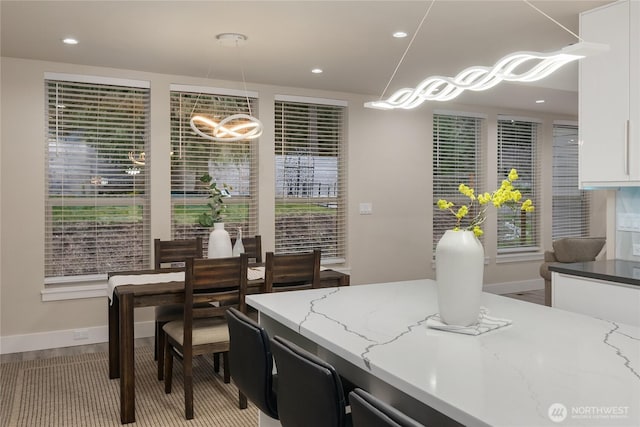 interior space featuring baseboards, wood finished floors, and recessed lighting