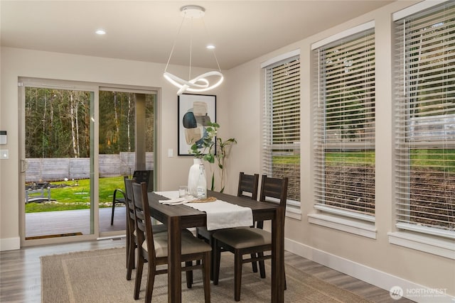 dining room featuring a chandelier, recessed lighting, wood finished floors, and baseboards