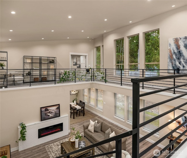 living room featuring plenty of natural light, wood finished floors, and recessed lighting