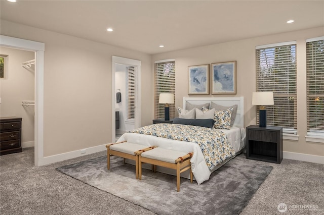 carpeted bedroom with a walk in closet, baseboards, and recessed lighting