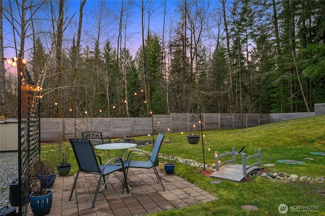 exterior space featuring outdoor dining space, a fenced backyard, and a patio