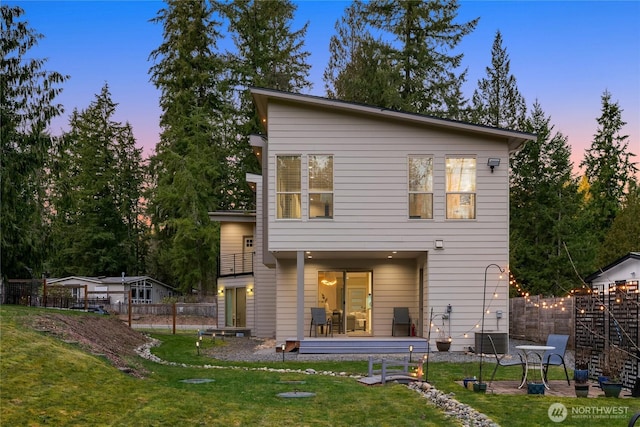 back of house with a yard, a patio area, and fence