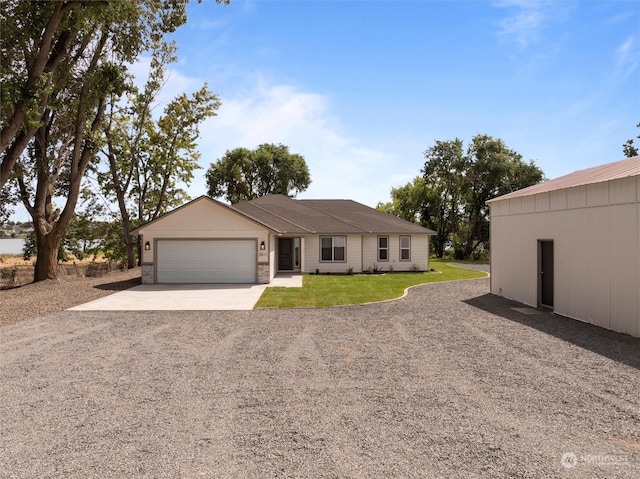 ranch-style home featuring a garage and a front yard