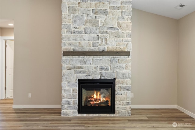 interior details featuring hardwood / wood-style flooring and a fireplace