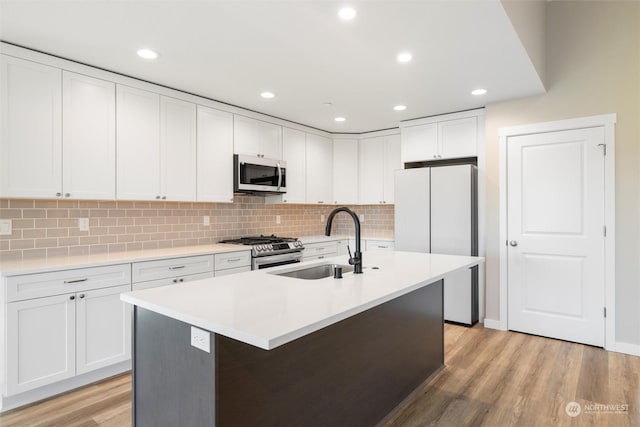 kitchen featuring white cabinetry, sink, a kitchen island with sink, and appliances with stainless steel finishes