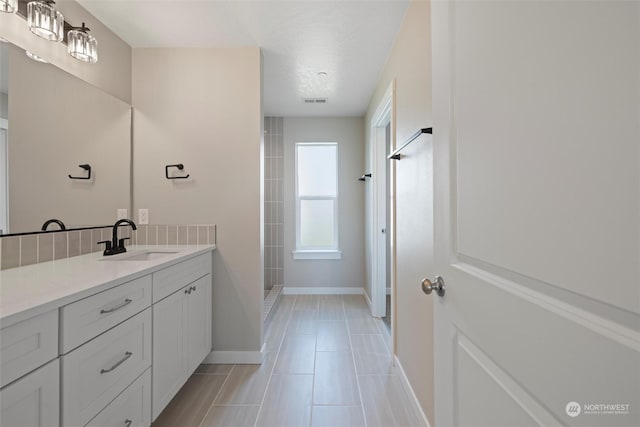 bathroom with vanity and a shower