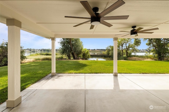 view of patio / terrace featuring ceiling fan and a water view