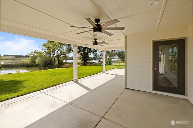 view of patio / terrace with a water view and ceiling fan