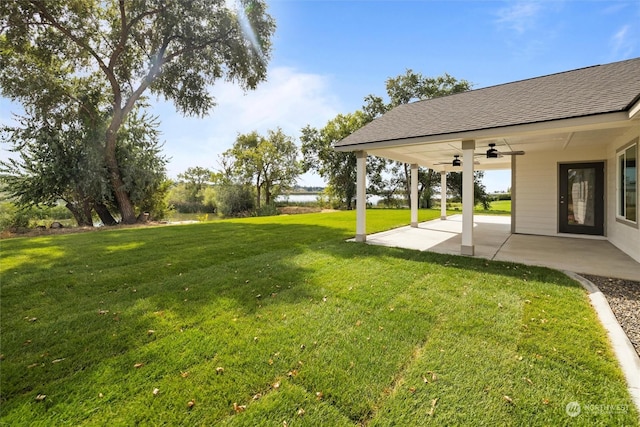 view of yard with a patio and ceiling fan