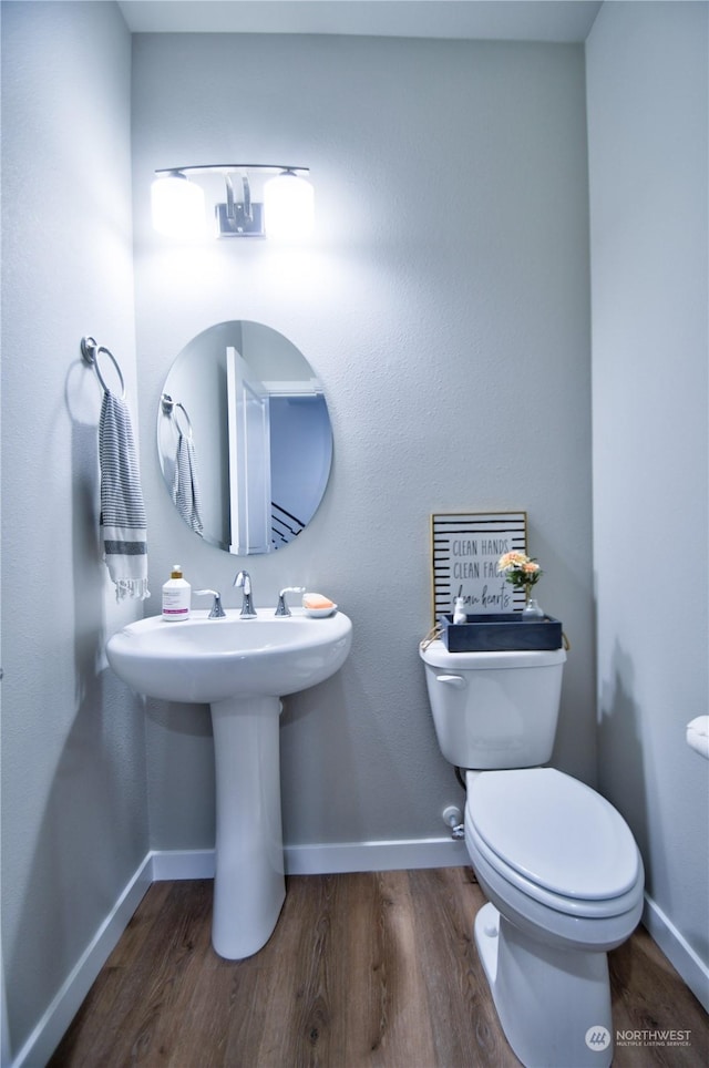 bathroom with sink, wood-type flooring, and toilet