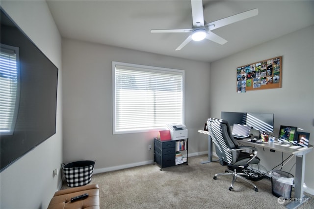 carpeted home office featuring ceiling fan