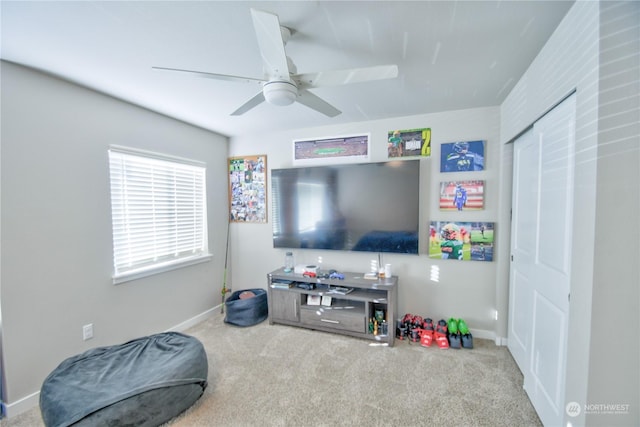 living room featuring carpet floors and ceiling fan