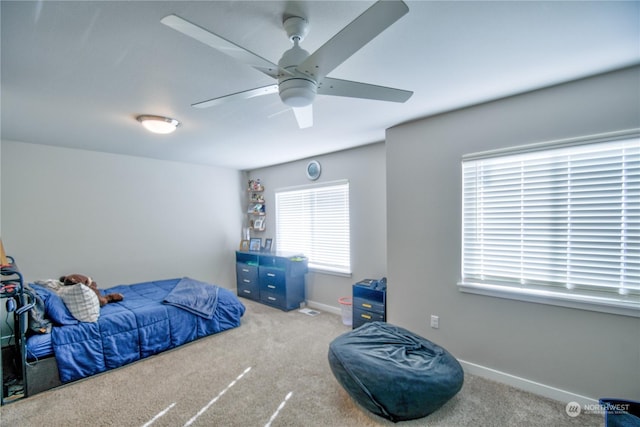 bedroom featuring ceiling fan and carpet