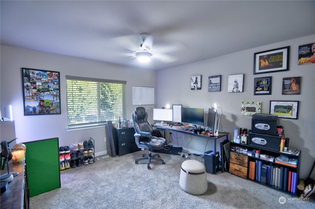 carpeted office space with ceiling fan