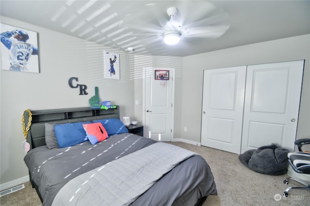 bedroom with light carpet, ceiling fan, and a closet