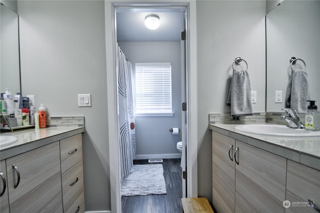 bathroom with vanity, wood-type flooring, and toilet