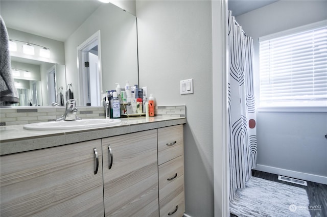 bathroom featuring tasteful backsplash, vanity, and a shower with curtain