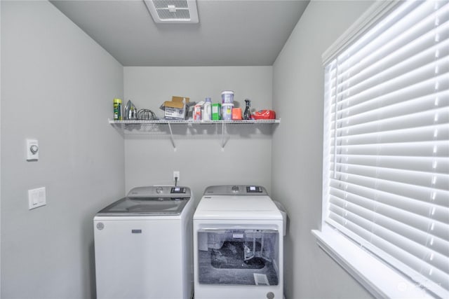 clothes washing area with washing machine and clothes dryer