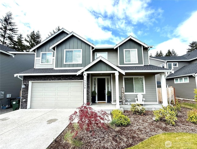 15530 Bergh Ct SE, Yelm, WA 98597 - view of front of property featuring board and batten siding, concrete driveway, a porch, a garage, and fence