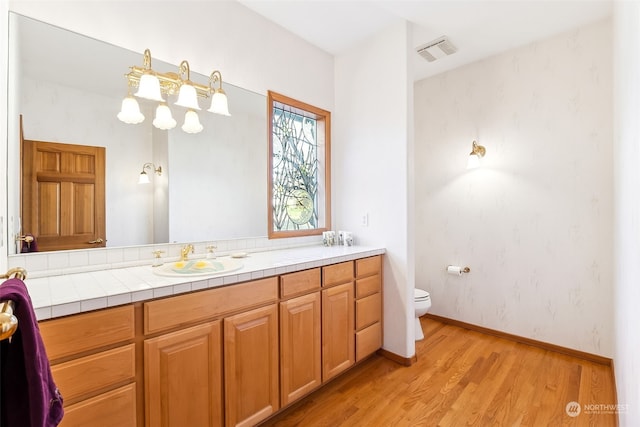 bathroom featuring vanity, hardwood / wood-style floors, and toilet