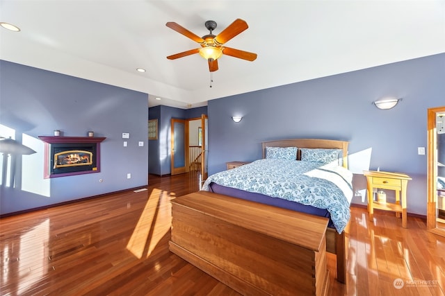 bedroom with hardwood / wood-style floors and ceiling fan