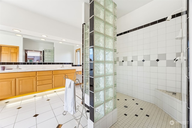 bathroom featuring tiled shower, tile patterned floors, and vanity