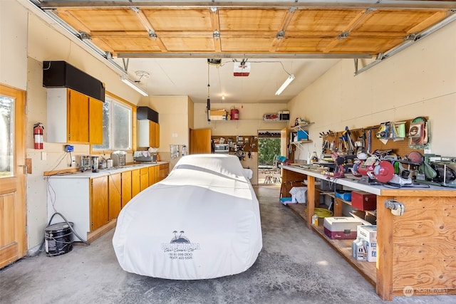 garage with a garage door opener and a workshop area