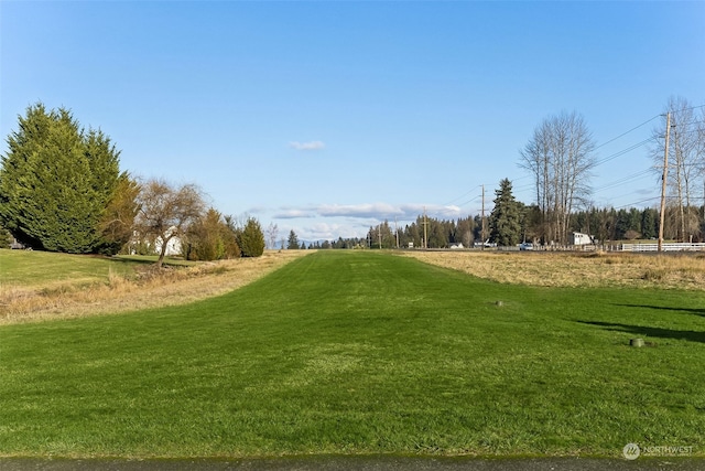 view of home's community featuring a rural view and a lawn