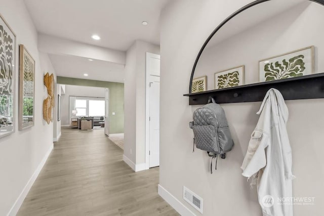 mudroom with light hardwood / wood-style floors