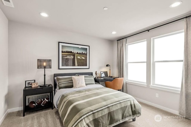 carpeted bedroom with multiple windows