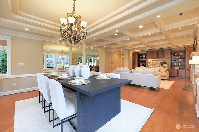 dining room with crown molding, dark hardwood / wood-style flooring, and a chandelier