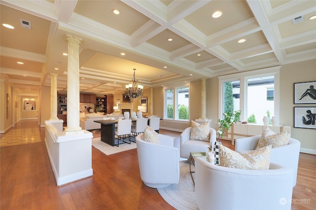 living room featuring decorative columns, ornamental molding, coffered ceiling, and beam ceiling