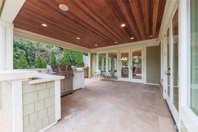 view of patio / terrace with an outdoor kitchen, a grill, and french doors