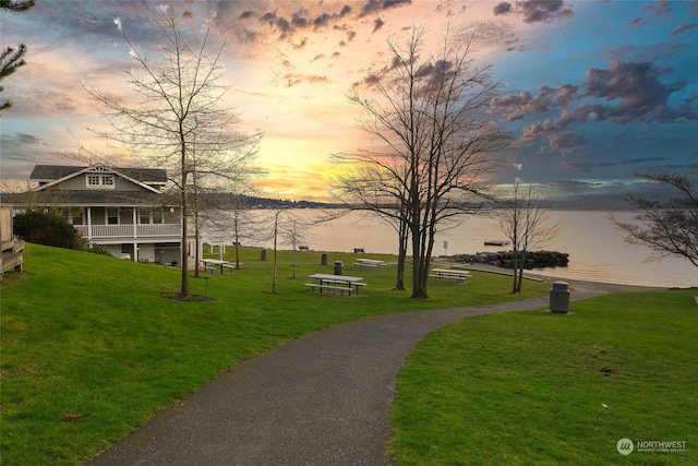 view of home's community featuring a yard and a water view