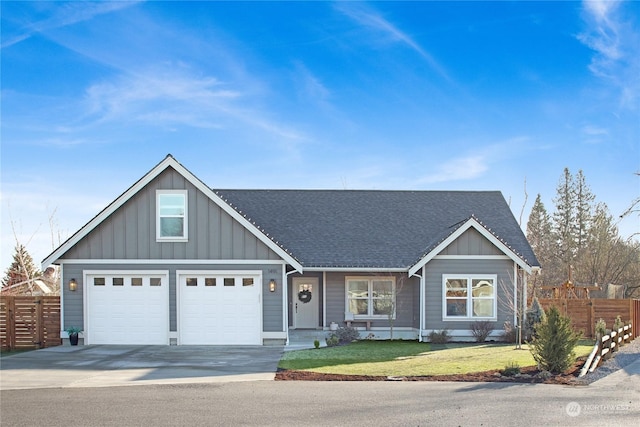 view of front of house featuring a garage and a front lawn