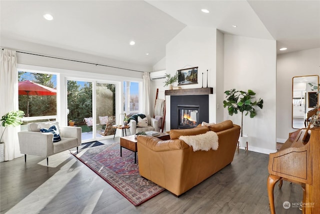 living room with vaulted ceiling, dark hardwood / wood-style floors, and a wall mounted air conditioner