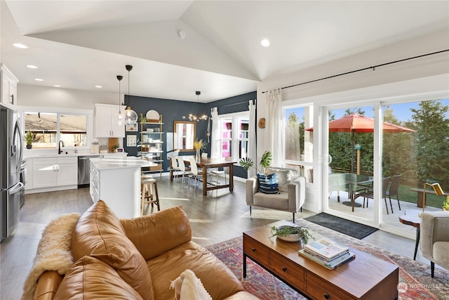 living room with lofted ceiling, dark hardwood / wood-style flooring, and sink