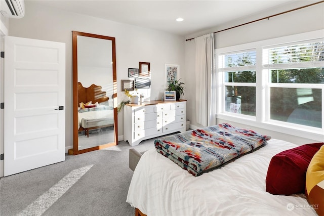 bedroom featuring an AC wall unit and carpet flooring