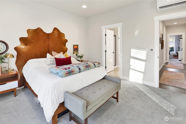 bedroom with light carpet and an AC wall unit