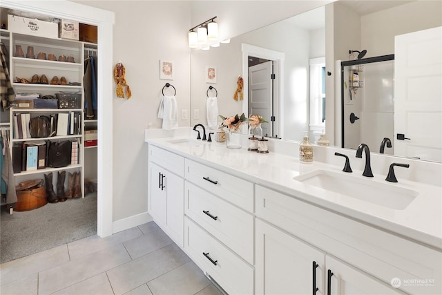 bathroom with vanity, tile patterned flooring, and walk in shower