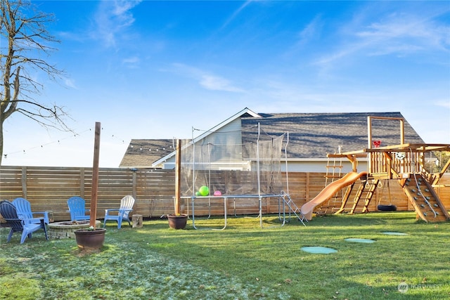 view of playground featuring a trampoline and a yard