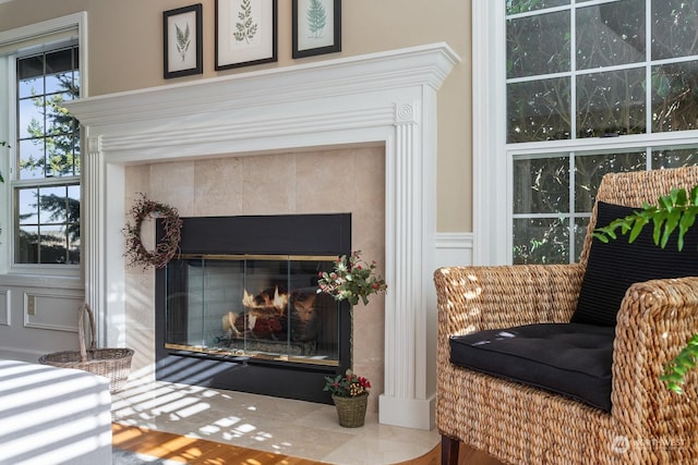 details with a decorative wall and a tiled fireplace