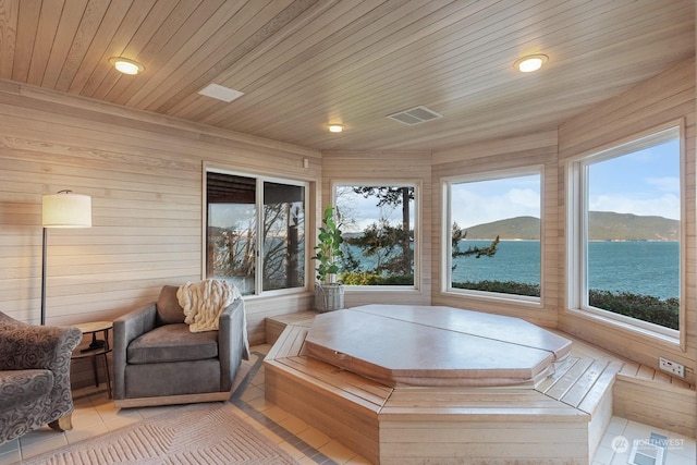 sunroom / solarium with wooden ceiling, visible vents, and a mountain view